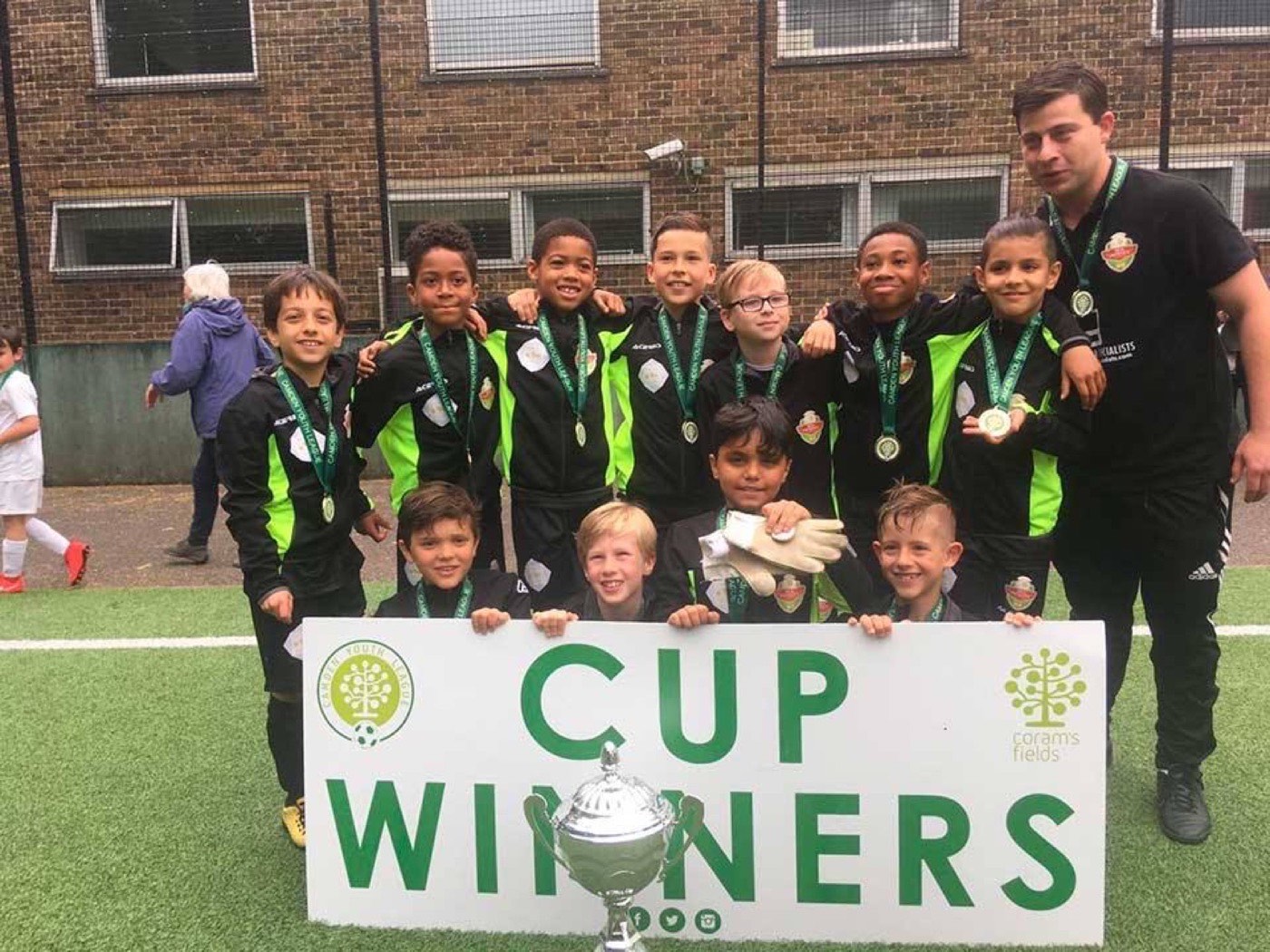 PFA United team holding a Cup Winners banner